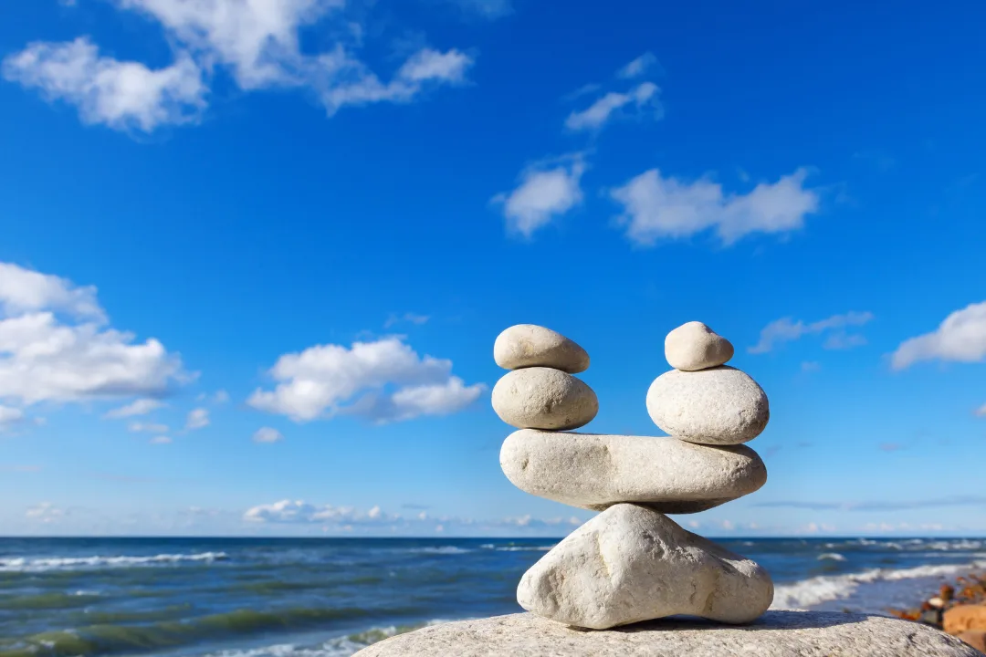 Balanced stones symbolizing self-worth beyond work on Sadhuwani blog